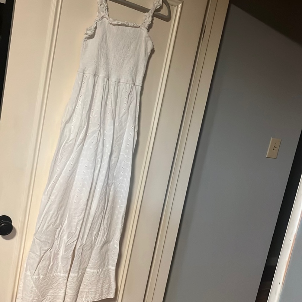 All white jumpsuit has pockets